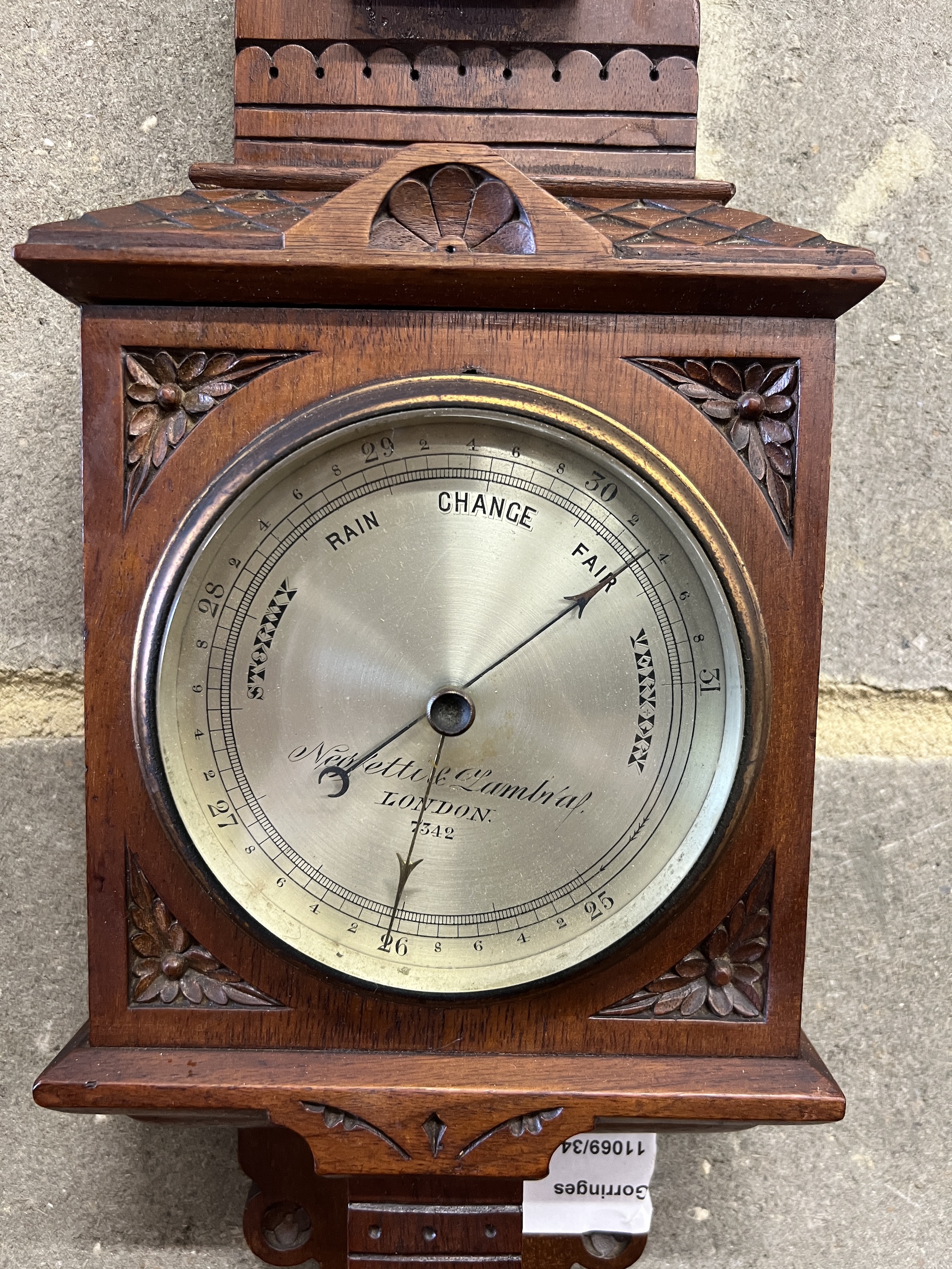 A Victorian walnut cased aesthetic movement style aneroid barometer and thermometer, Negretti & Zambra, London, numbered 7342, height 68cm